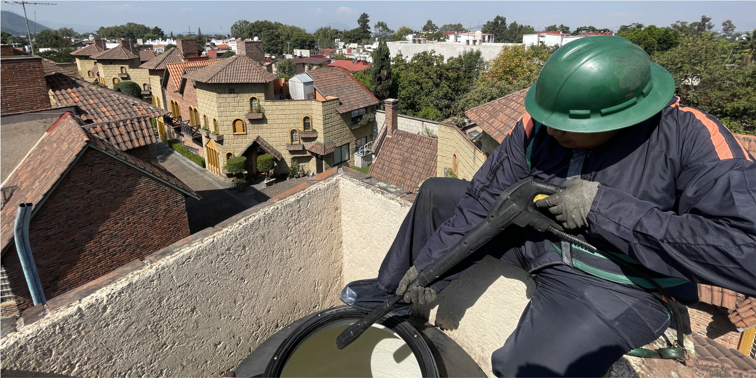 Técnico realiza desinfección a tinaco durante el lavado de cisternas y tinacos en Cuauhtémoc