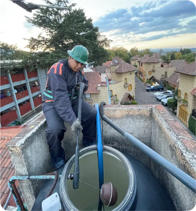 Técnico realiza un enjuague durante la limpieza de tinacos en Tultitlán